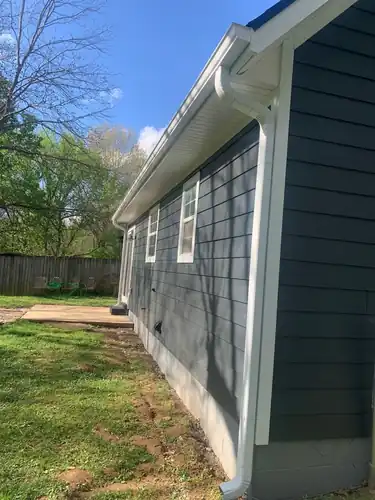 Side elevation of the Fayetteville LP siding job with gutter and downspout
