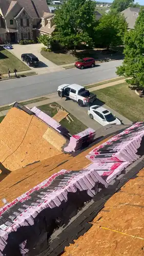 Owens Corning Duration shingle bundles staged on new OSB roof decking in Rogers, Arkansas